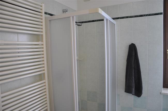 bathroom with shower and washing machine