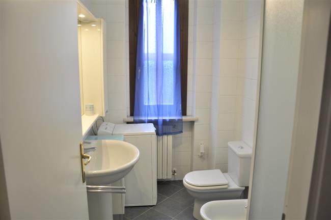 bathroom with shower and washing machine