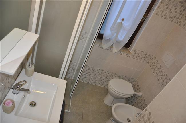 bathroom with shower and washing machine