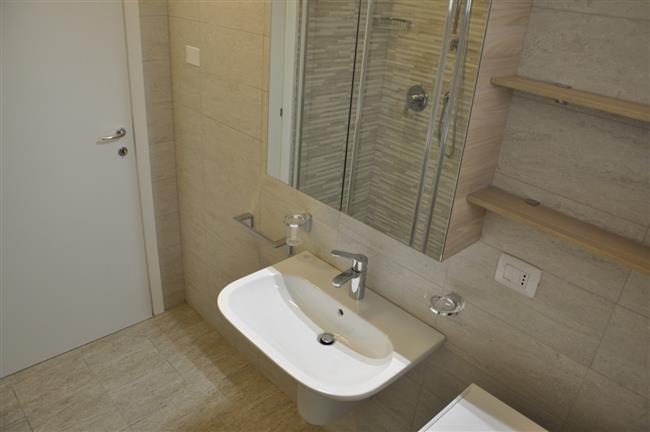 bathroom with shower and washing machine