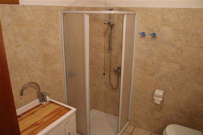 bathroom with shower and washing machine