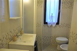 bathroom with shower and washing machine