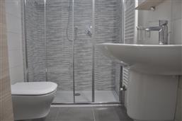 bathroom with shower and washing machine